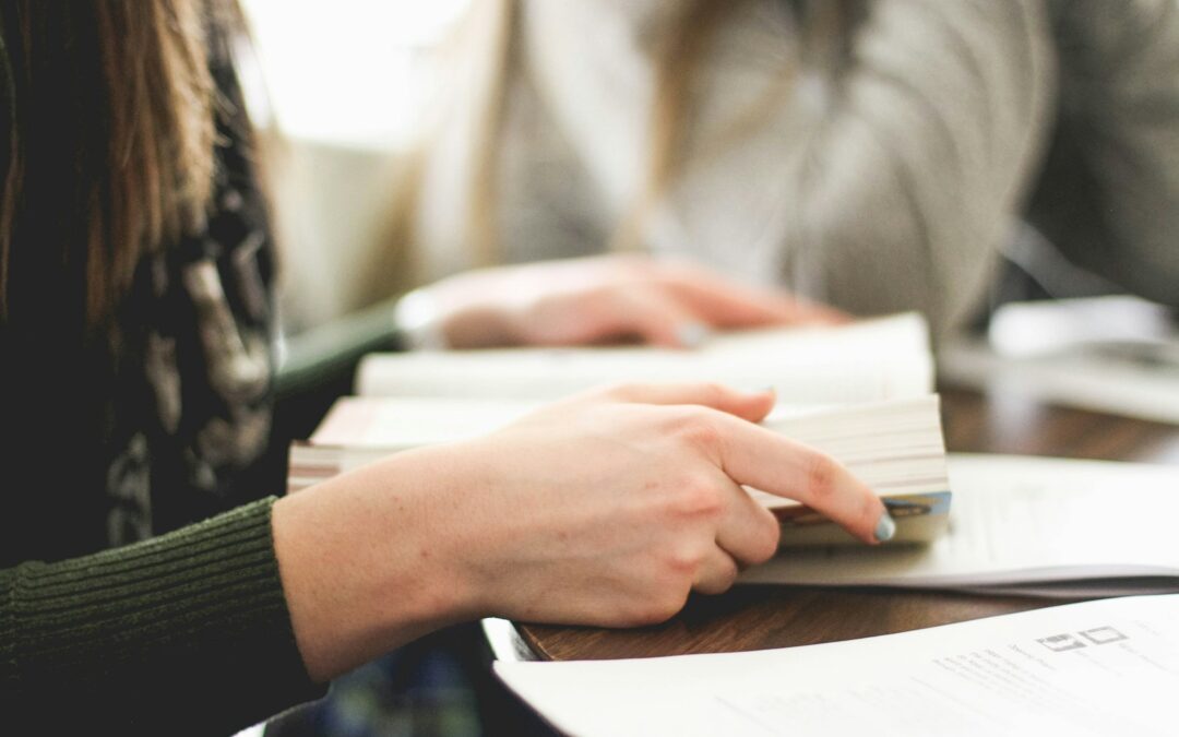 woman sitting on chair in front of table white reading book